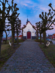 White chapel in Herenthout, Belgium, called Uilenberg or "our lady of the seven sorrows". The chapel was already build before 1640 and restored in 1705 after looting by soldiers and robbers.