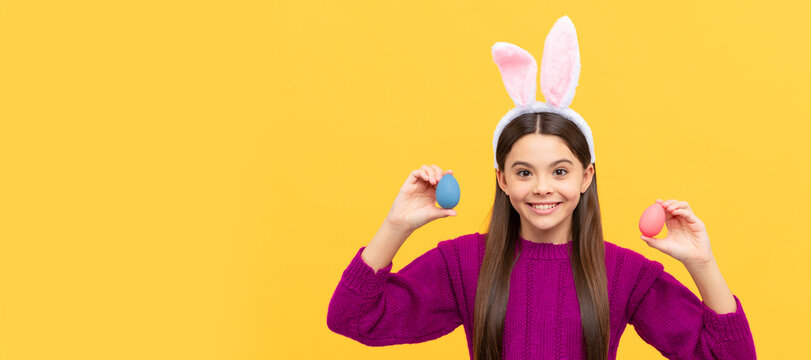 happy teen kid in bunny ears with painted eggs. Easter child horizontal poster. Web banner header of bunny kid, copy space.