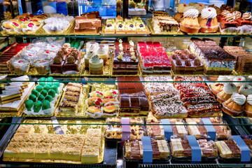 Obraz premium Showcase of different cakes in a confectionery shop