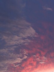 Dramatic colored clouds in sunset sky, portrait orientation