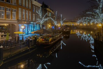 18 January 2019 Leiden, Netherlands, view of the New Rhine with canal houses, illuminated trees, buildings and bridges