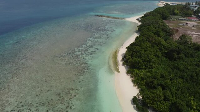 Tropical paradise with blue sea and green island in the maldives