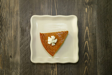 Top view of a slice of crust less pumpkin pie.