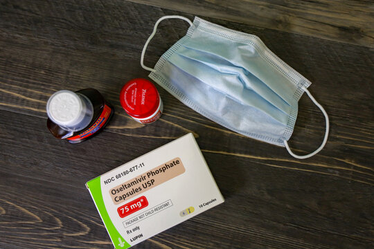View of flu medicine and protective mask. San Diego, CA USA on January 6, 2020. Oseltamivir Phosphate capsules (Tamiflu), Tylenol and Delsym cough medicine.