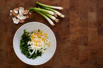 Plate with green onion and eggs