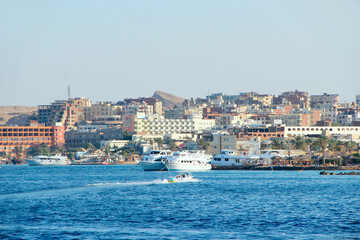 View of embankment of Hurghada with moored yachts, ships and beautiful mosque
