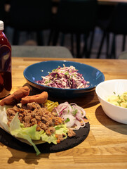Combo lunch at the food court. Totilla, red cabbage salad and drink. selective focus