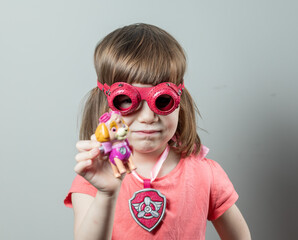 Paw Patrol. A child dressed as Sky, the hero of the animated series. Portrait of a girl in pink...