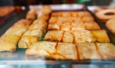 Fresh pastries behind the glass of a cafe on the street.
