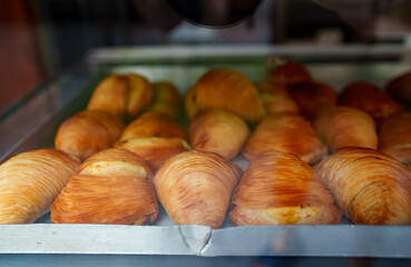 Fresh pastries behind the glass of a cafe on the street.