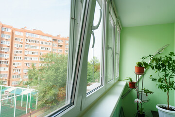 interior of the balcony with large glazed windows in the apartment. 