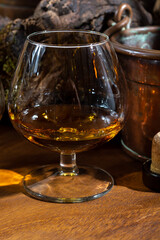 Tasting of aged french cognac brandy alcoholic drink in old cellars of cognac-producing regions Champagne or Bois, France