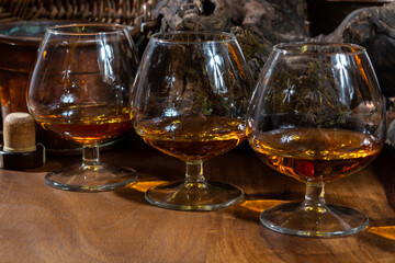 Tasting of aged french cognac brandy alcoholic drink in old cellars of cognac-producing regions...