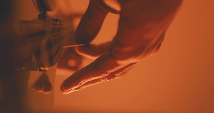 Close up of a musician playing an acoustic f-style mandolion