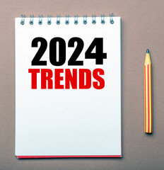 TRENDS 2024 words in an office notebook.