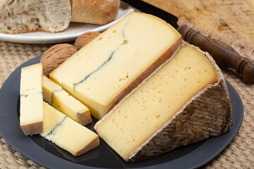 Cheese collection, French cheeses Morbier semi-soft cow milk cheese with black mold layer and Tomme...
