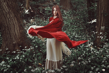 Red cloaked girl in a fantasy forest