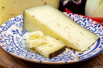 Cheese collection, aged hard Italian sheep cheese black pecorino from Sicily island or pecorino nero di Sicilia