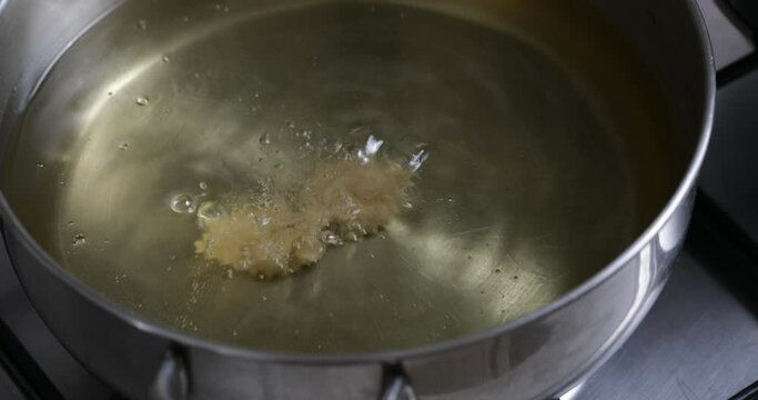 Culinary delight in the making: chebakia takes its final plunge, emerging from the fryer as a golden masterpiece