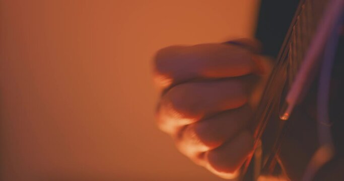 Close up of a musician playing an acoustic f-style mandolion