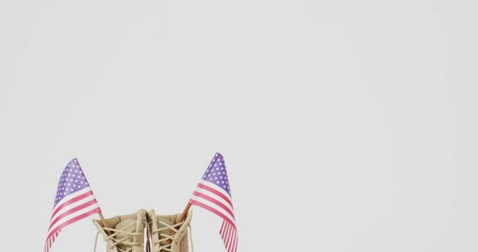 Close up of national flags of usa and beige shoes on white background with copy space
