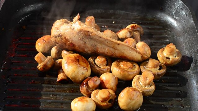 We fry mushrooms with chicken on a grill. We cook a