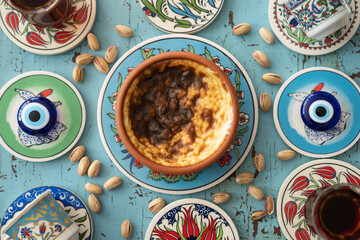 Photograph of Rice Pudding (Turkish Sutlac) in Ottoman Tile Turkish Coffee Cup and Turkish Tea Concept, Uskudar Istanbul, Turkey	