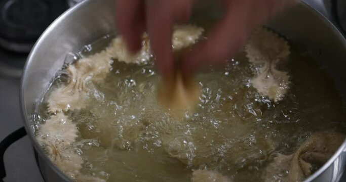 Golden treasures in the making: observe chebakia frying to perfection, releasing enticing aromas in the kitchen.