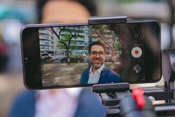 Young Latin man sitting in an abandoned castle from colonial times in South America. Copy space.