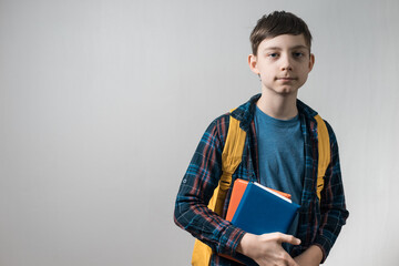 kid pupil in casual clothes with school bag and books