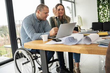 A physically challenged husband, works from home, supported by his wife. Together, they create an atmosphere of unity, sharing moments of joy.