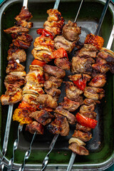 Bbq grilled meat pork, chicken and vegetable skewers on tray. Top view, flat lay