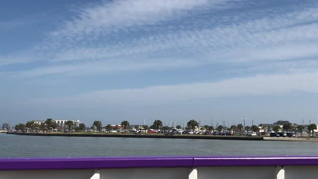 PORT ARANSAS, TX - 14 FEB 2023: Crossing the water to Port A, Texas with POV from a ferry crossing the ship channel between the Gulf of Mexico and Corpus Christi, as it approaches the dock.