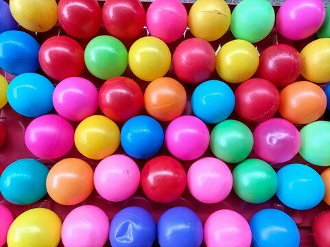 Top view of multicolor plastic balls in a container for toys and children's education at home. Many colorful plastic balls are often used as backgrounds, illustrations, wallpapers and 3d rendering.