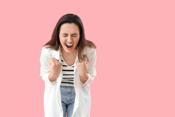 Stressed screaming woman on pink background