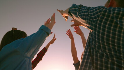 Many people raised their hands to sky, concept of unity and teamwork. Business people outdoors....