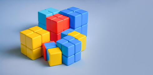 Cubes red blue and yellow, blue background copy space. Сhildren educational game, educational toys. Illustration, Generative AI
