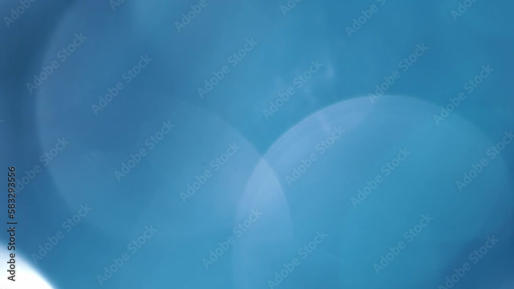 Wall mural blue large bokeh circular motion background. moving 4k background. huge defocused bokeh circles smoo