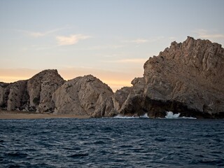 Fototapeta na wymiar Strong waves crash against the rocks lining the coast of Baja California Sur