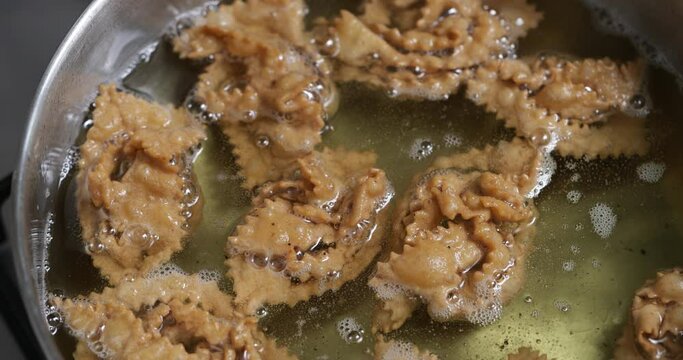The delicious sizzle of chebakia in the pan&mdash;a sensory experience that precedes the sweetness of the final stage
