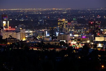 Looking down on Hollywood as night falls on the city and the lights of Los Angeles begin to...