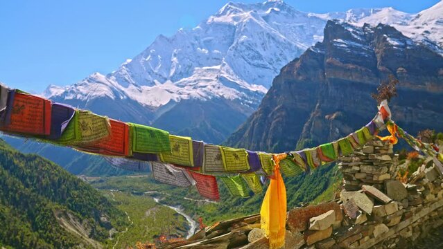 Colorful Buddhist prayer flags at a viewpoint overlooking the Annapurna mountain range, Nepal