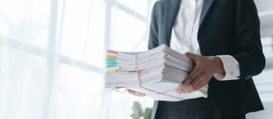 Paper stack, unfinished document, Close up hands of asian bookkeeper female working with stack of...