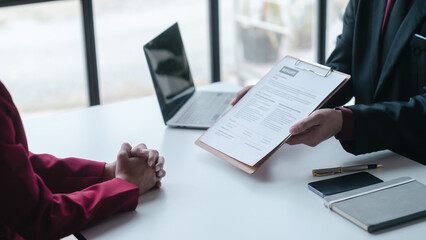 Close up view of job interview with applicant with resume paper in office, Recruitment, Job application concept.