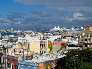 Fototapeta na wymiar Looking over Old San Juan and the Bahía de San Juan, as cruise ships arrive at the cruise ship port.