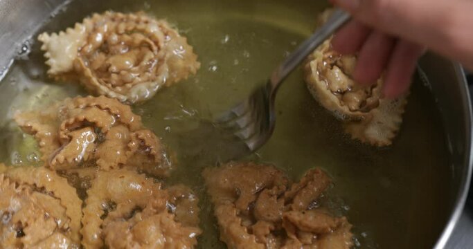 Watch as chebakia indulges in a golden bath, emerging as a flavorful and enticing Moroccan sweet delight