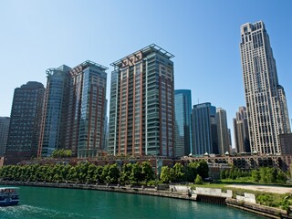Fototapeta na wymiar High rises loom above the Chicago River, forming a man-made canyon of buildings