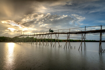 Obraz premium Farmers go to work on a bridge made of bamboo at Cam Dong village, Quang Nam province, Vietnam
