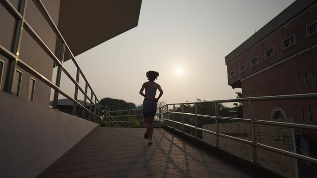 Asian Short Hair Woman Athlete Running Up The Stairs Training Workout Exercise Male Runner Legs Jogging On Steps In Urban City Background