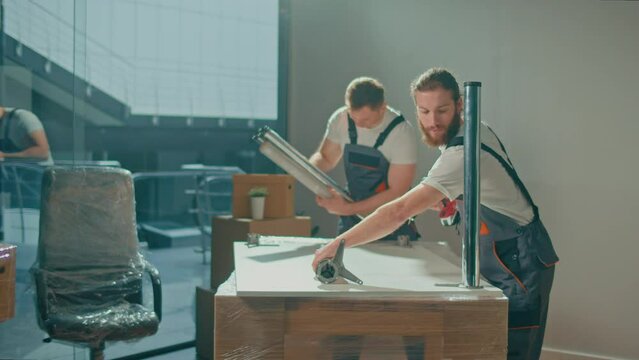 Workers of Moving Company With Uniforms Carefully Packing Furniture. Furniture and Equipment Disassembly and Assembly. Travel insurance. Team of Employee Workers Helps Customers to Relocation.